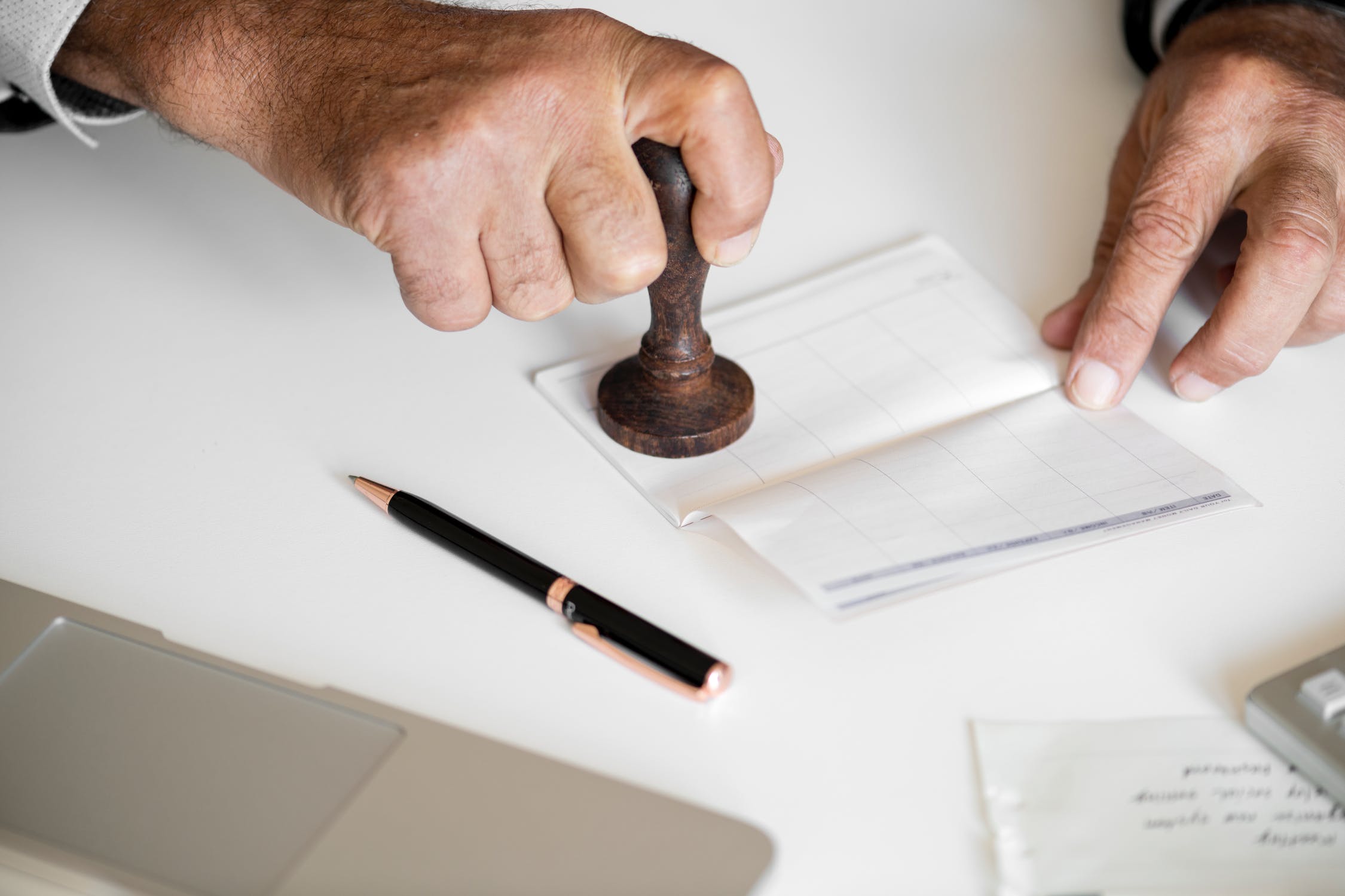 hands stamping a document