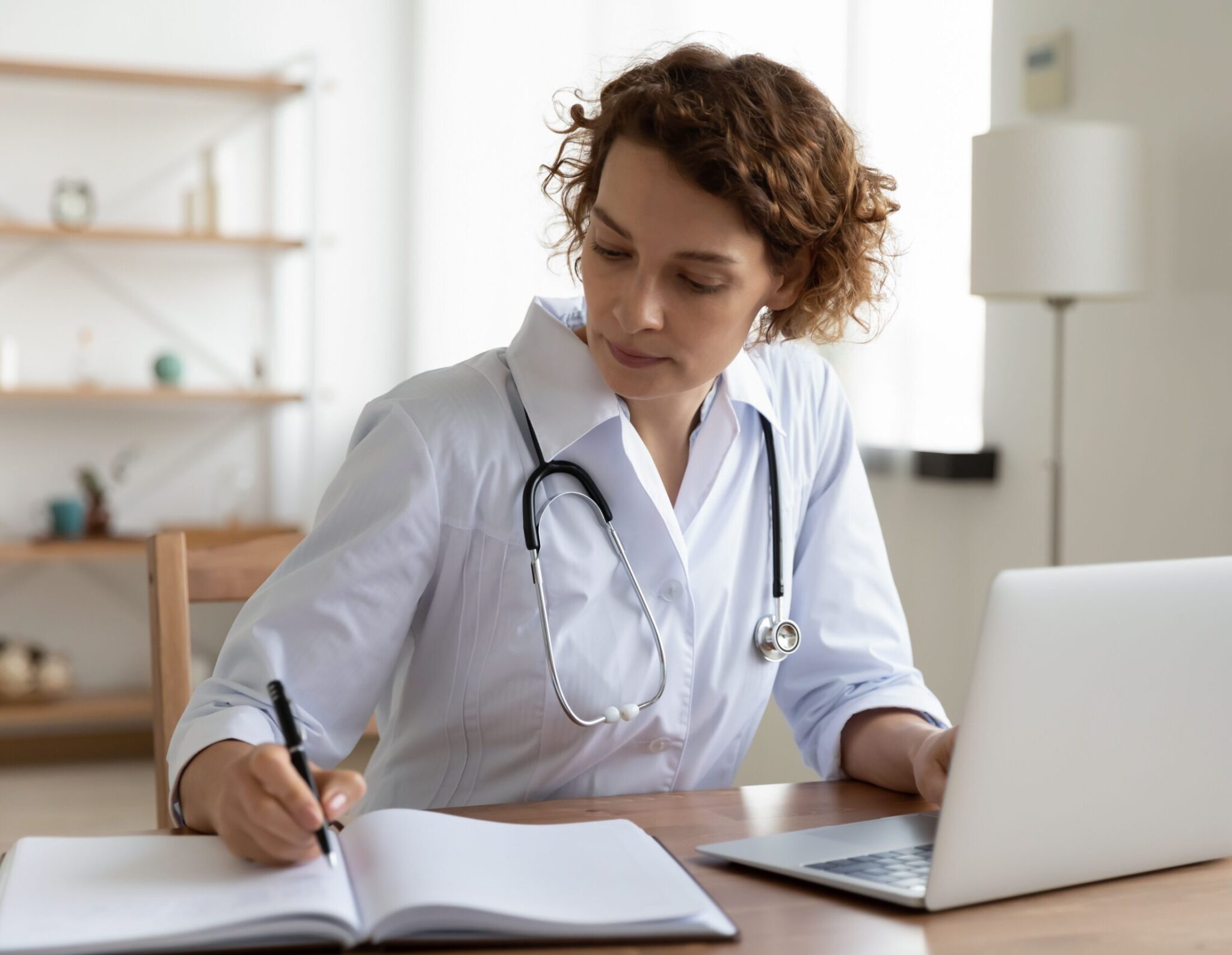 doctor taking notes at her desk