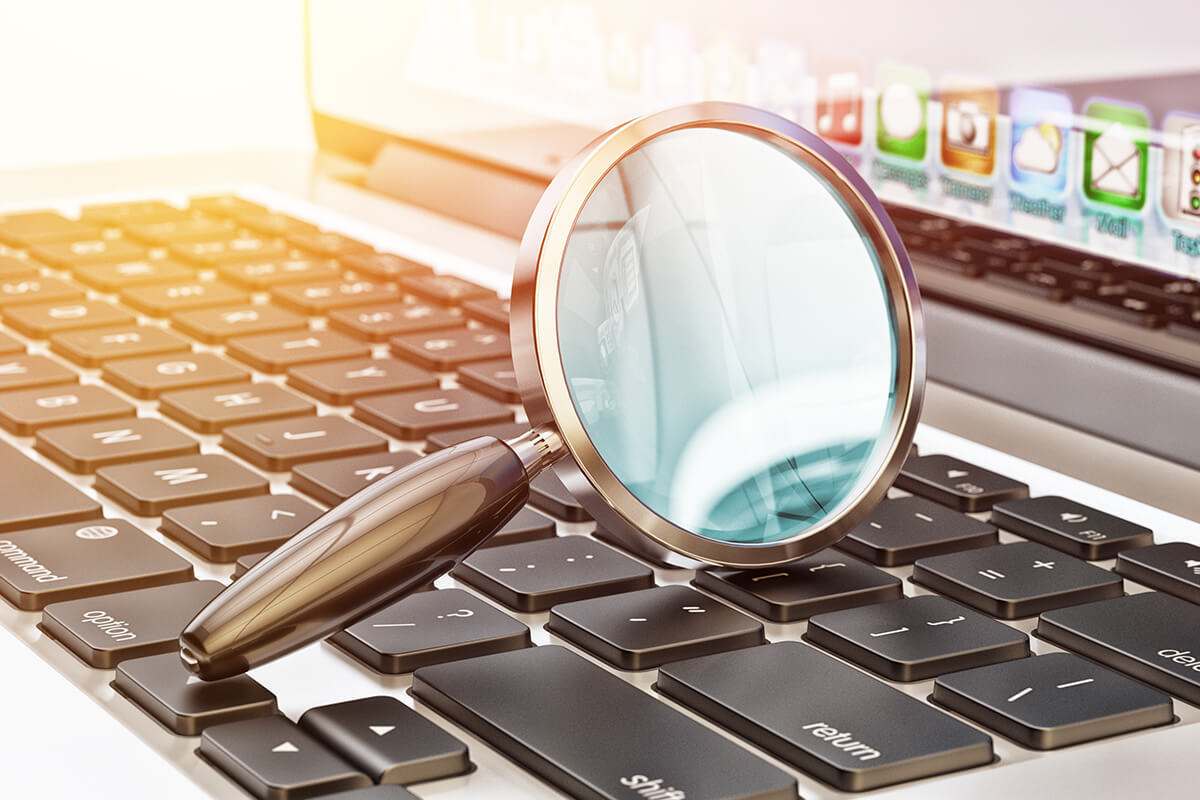 magnifying glass sitting on a keyboard