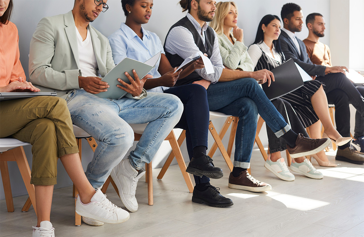 job applicants sitting waiting in line for interviews