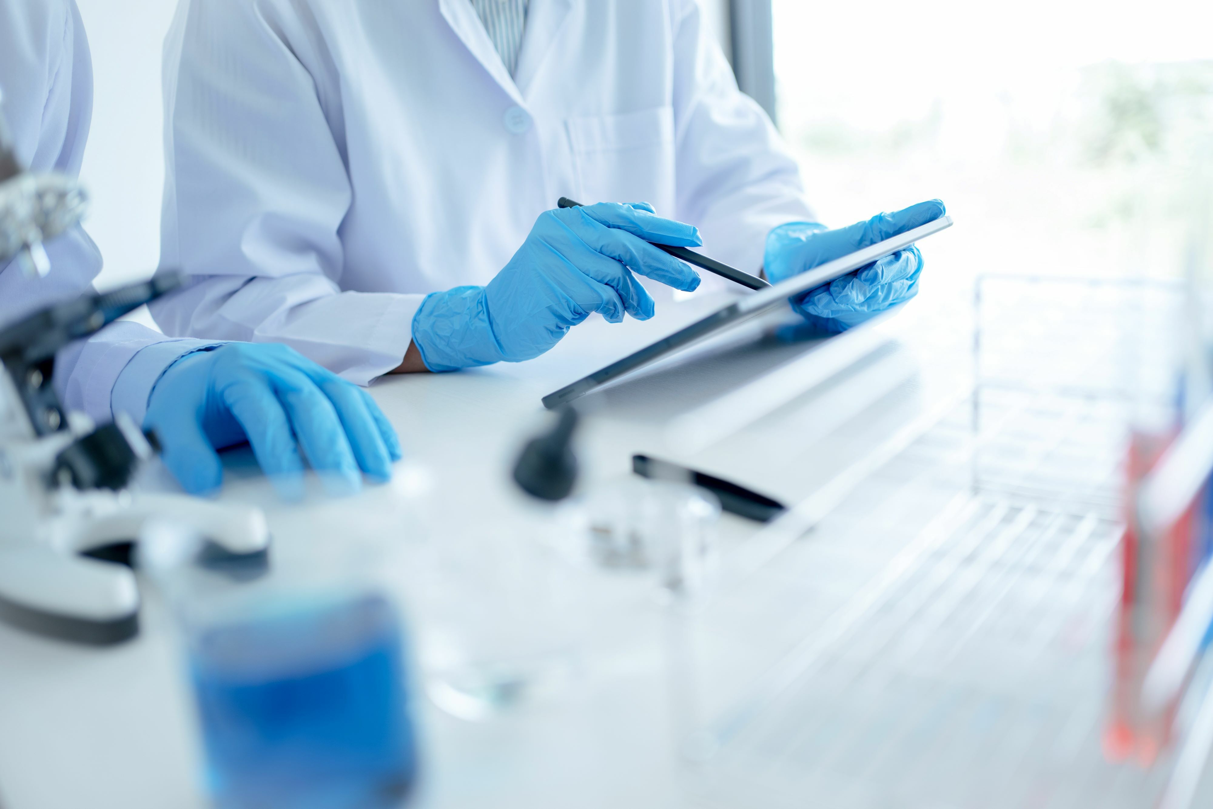 Lab techs working on a tablet