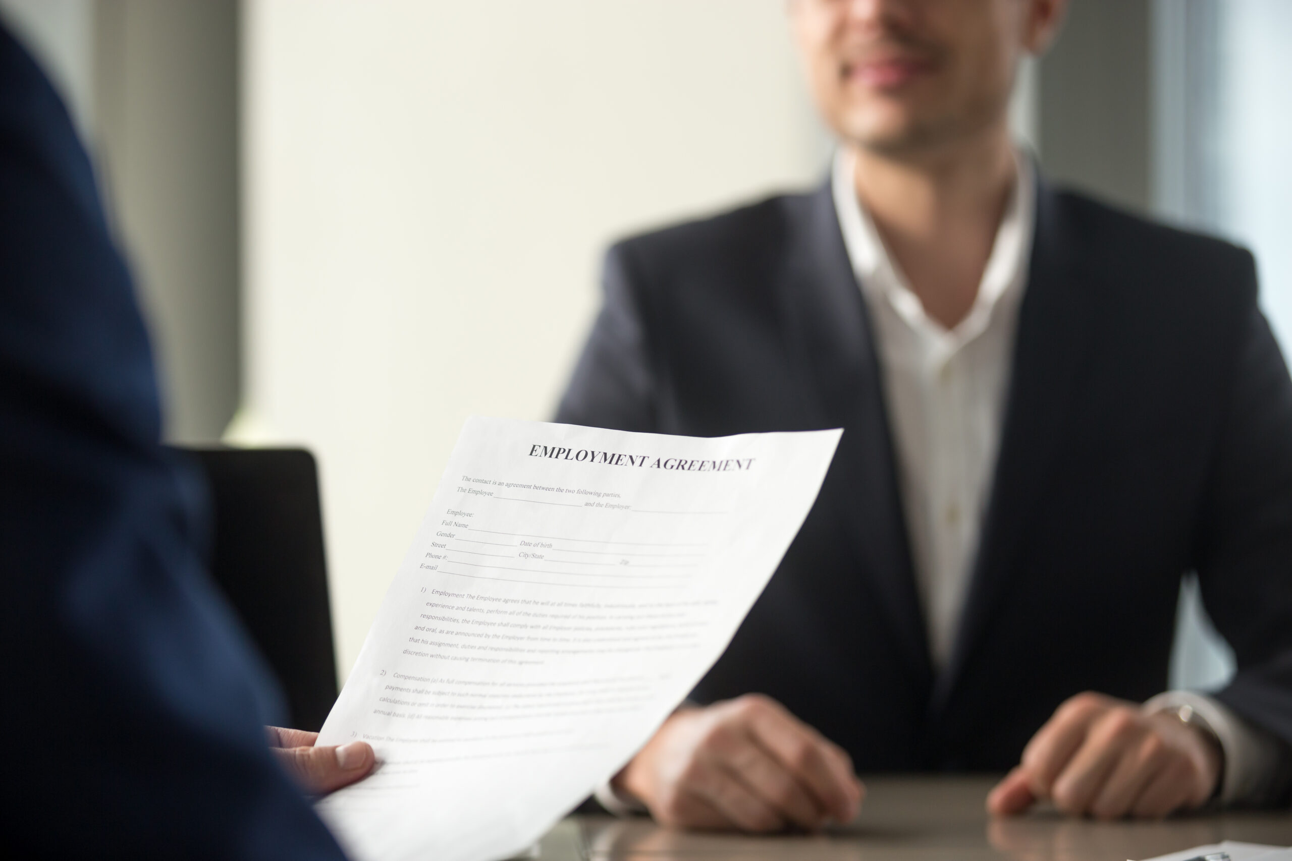 Future employee reads employment contract