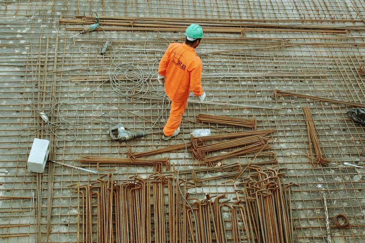 Construction working walking around among tools and materials