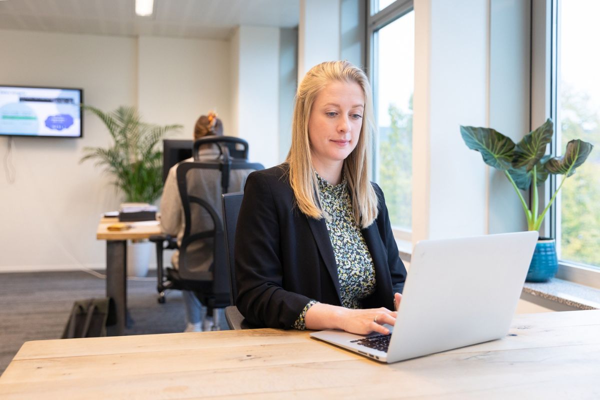 Blond woman reading about background checks on her computer
