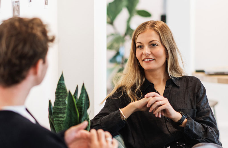 Woman in a scandinavian office enviroment talking about background checks in Denmark