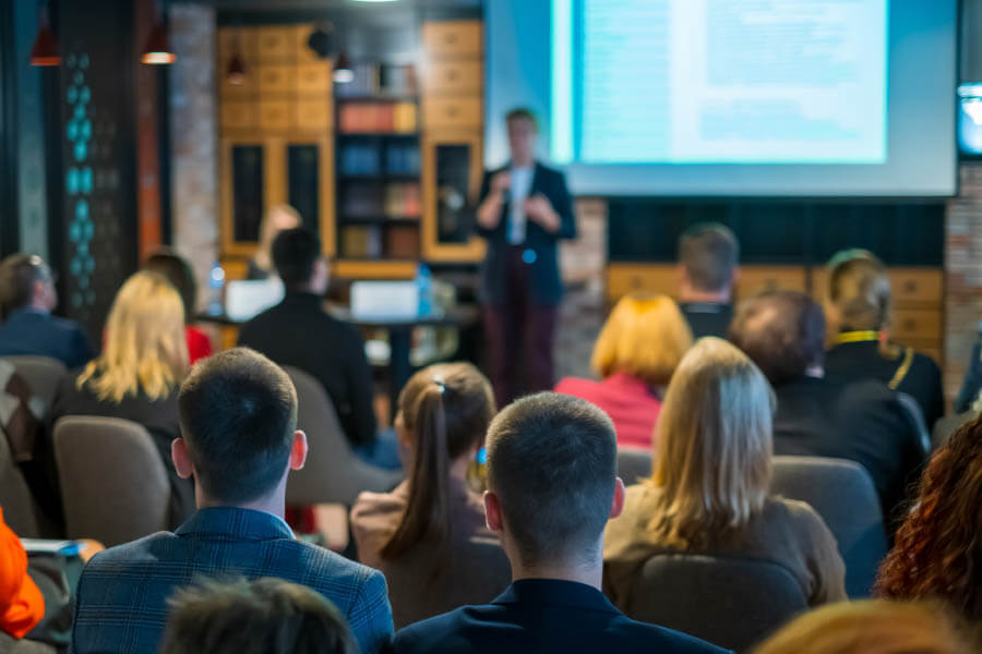 Audience listens speaker at conference