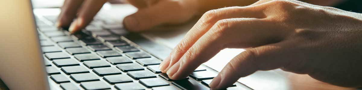 fingers on a laptop