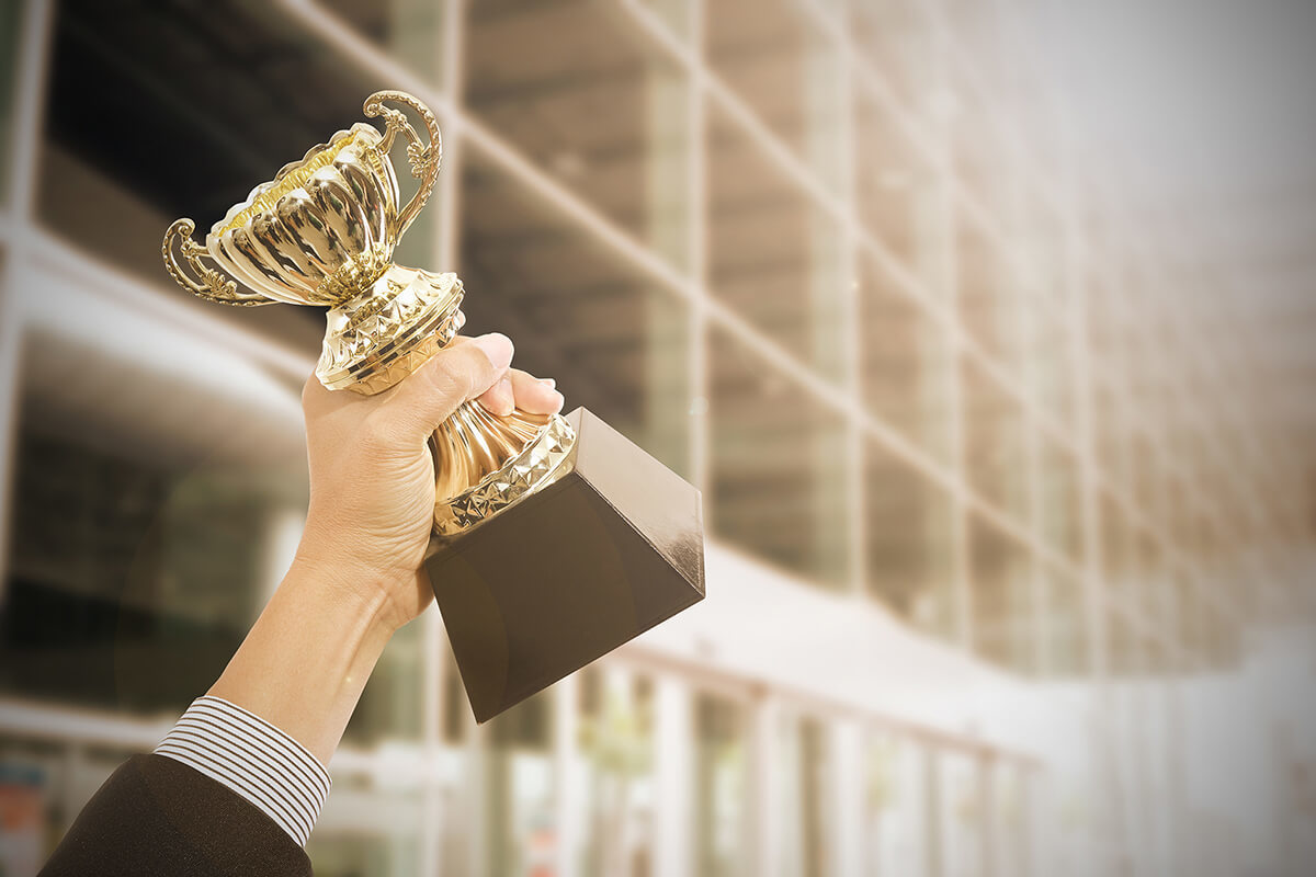 employee holding award celebration