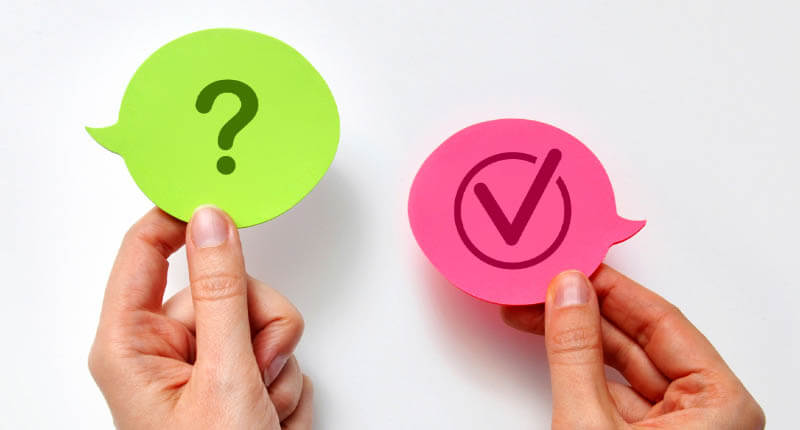 Hands Holding Question and Check Mark Speech Bubbles Decision Concept