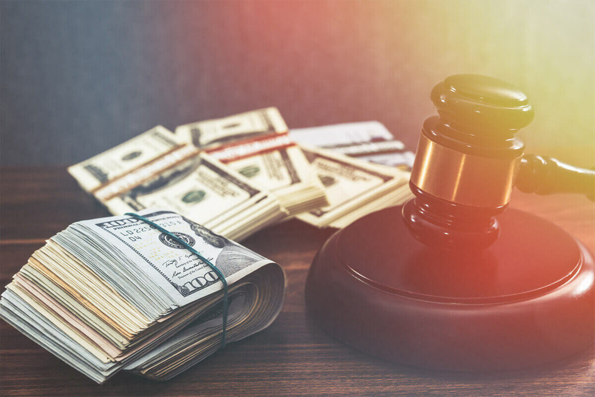Gavel with rolls of money representing fines imposed