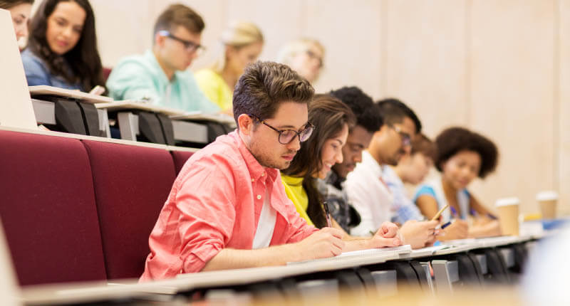 group of students with notebooks in lecture hall