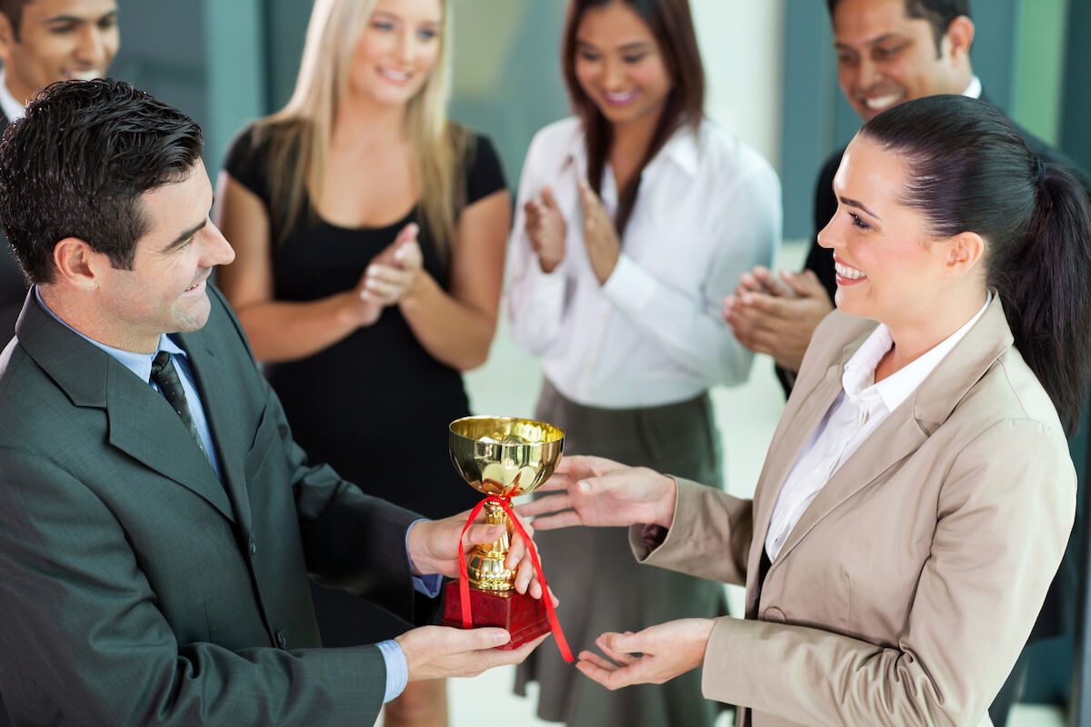 Background check award being presented between professional business people