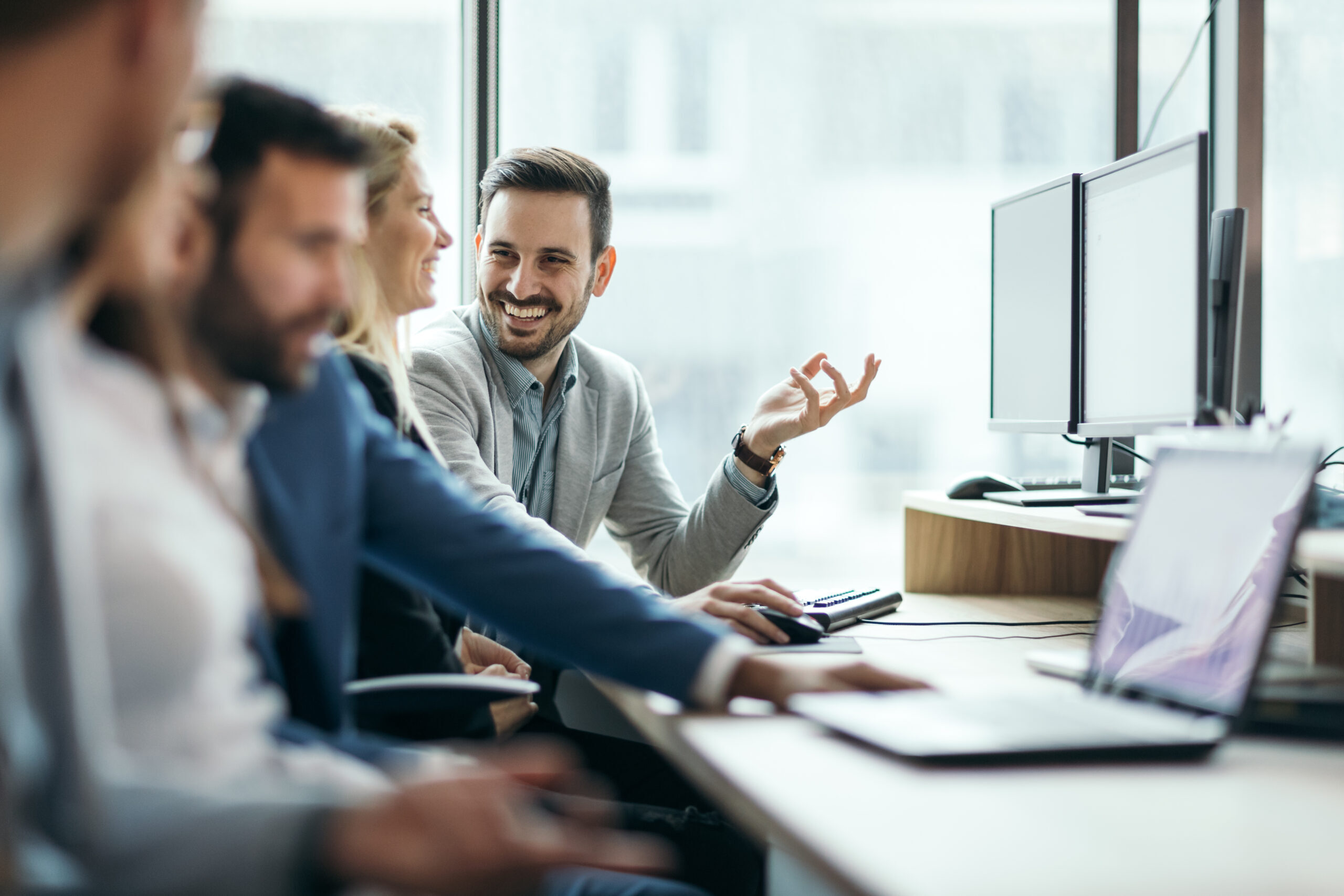 smiling talking employees in the office