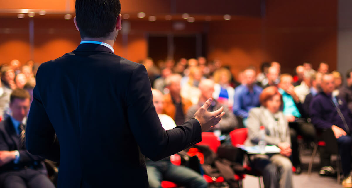 Speaker presenting at a conference