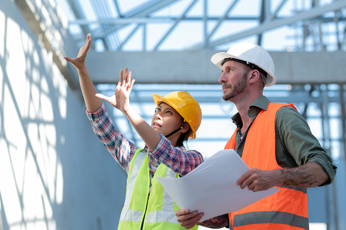 Young man and woman inspecting new buildings.