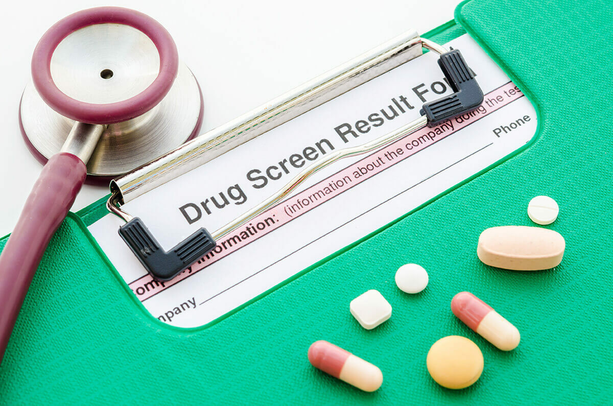 drug test results on a clipboard with pills