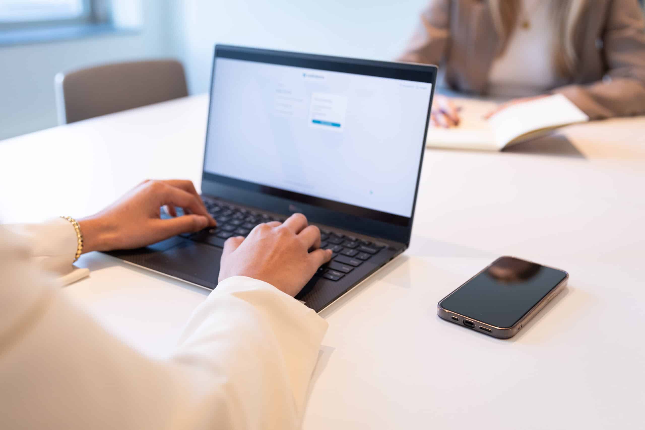 close up of someone typing on their laptop