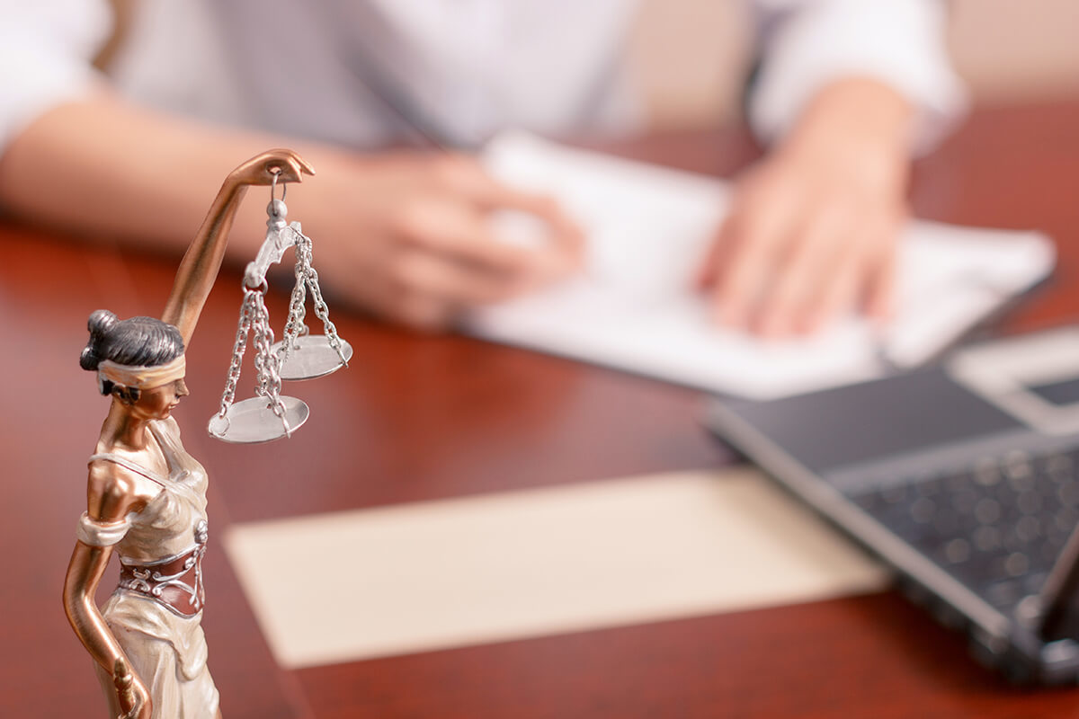 Scales of justice statue on a lawyer's desk
