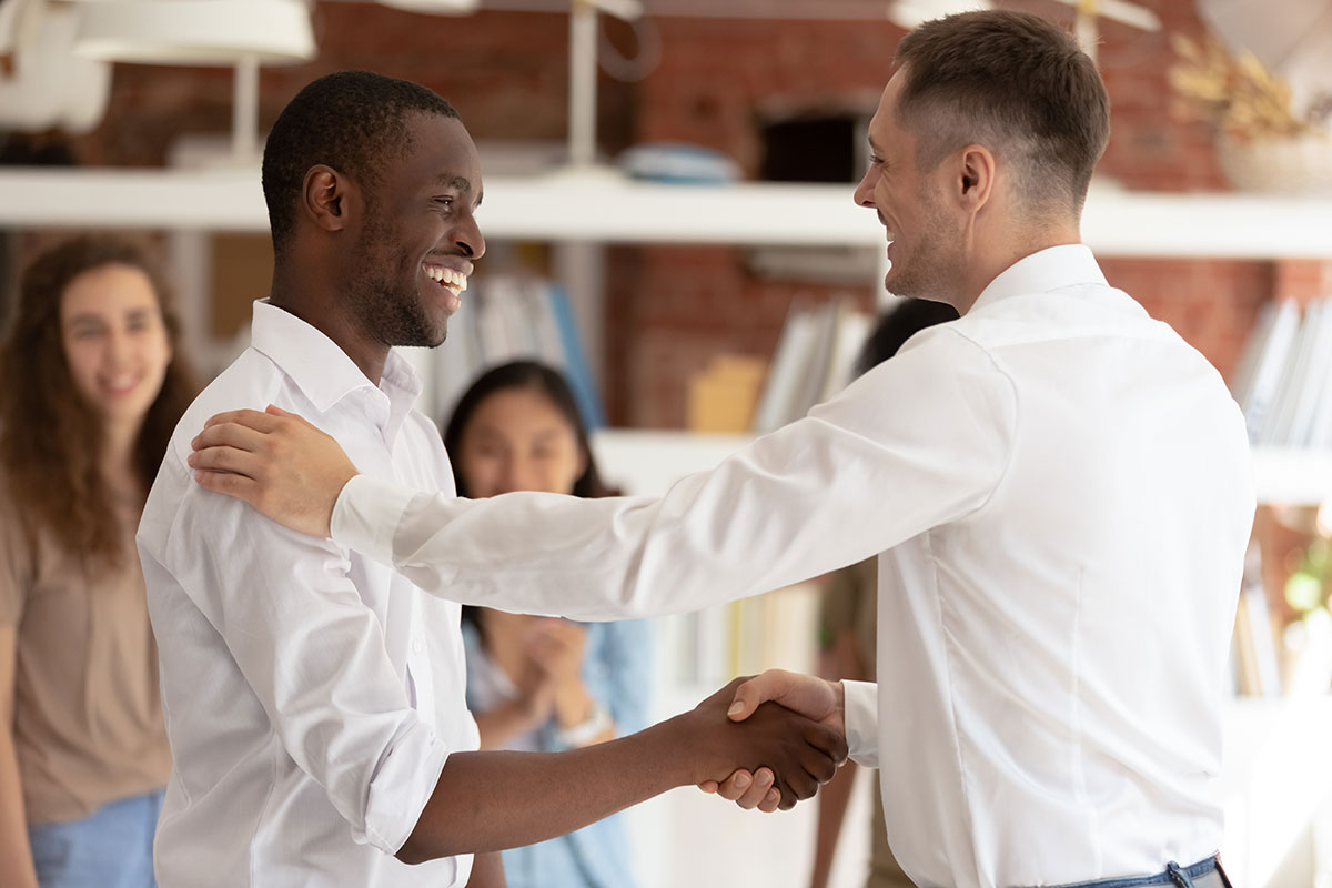Supervisor shaking hand of trusted employee