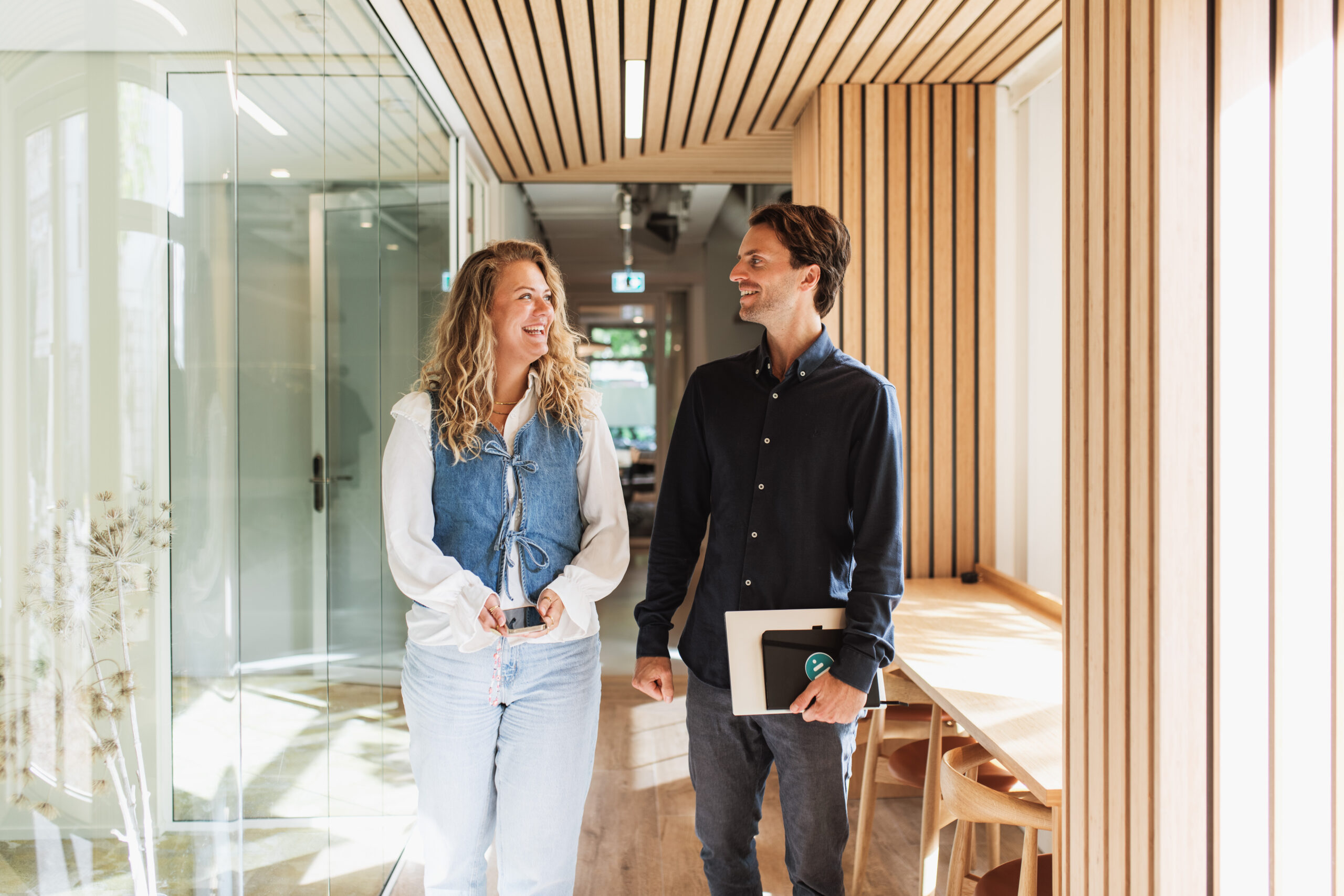 Two colleagues walking in a hallway