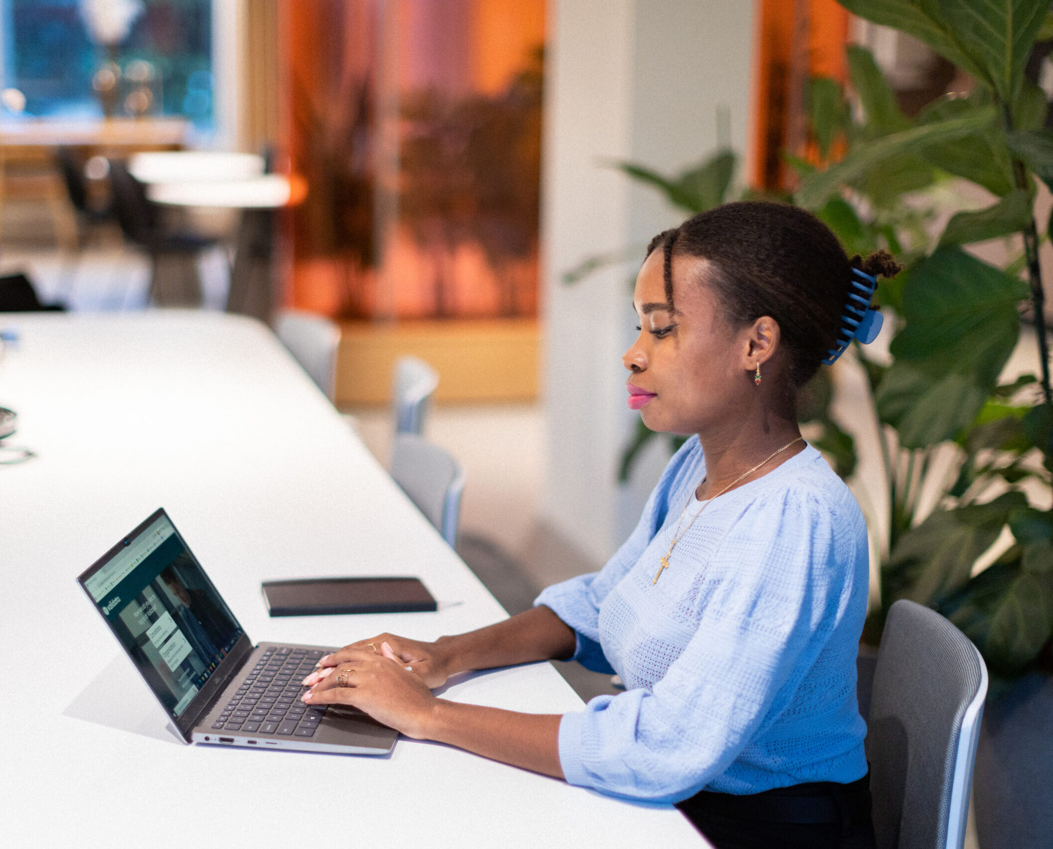 Woman sitting at a desk working on her laptop